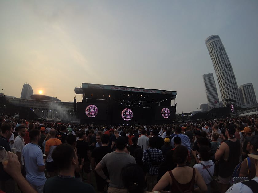 Concert nocturn al Padang Stage del circuit de F1 de Singapur amb públic i escenari il·luminat