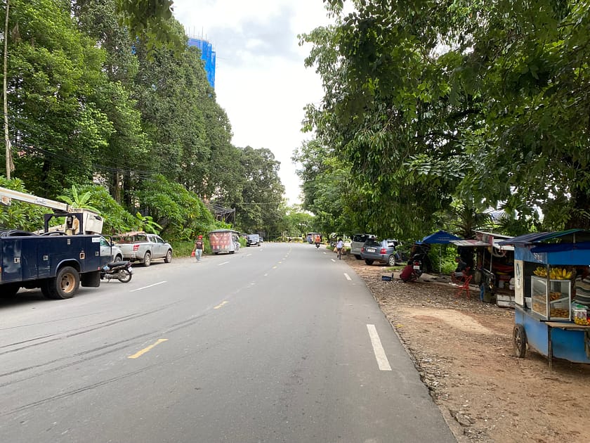Camí proper al port de Sihanoukville, amb ambient urbà i vegetació escassa, capturat durant un dia a Sihanoukville