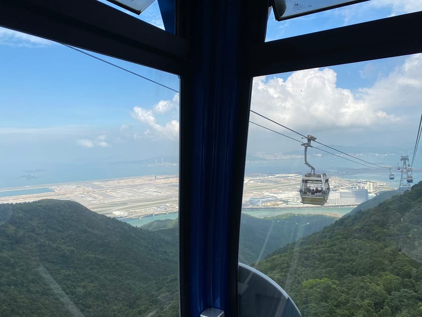 Telecabina Ngong Ping 360 sobrevolant Lantau amb el Gran Buda al fons