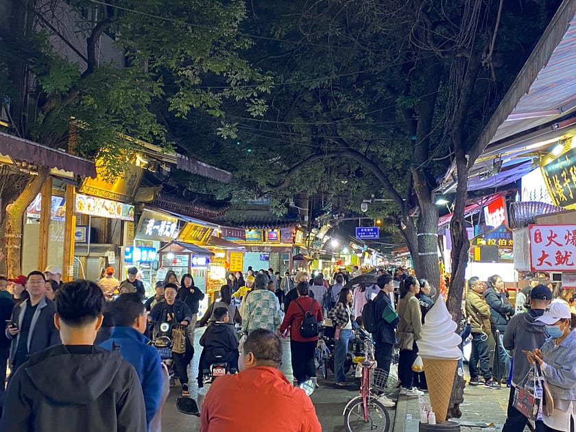Carrer de Xi’an de nit amb llumetes, gent passejant i parades de menjar i artesania